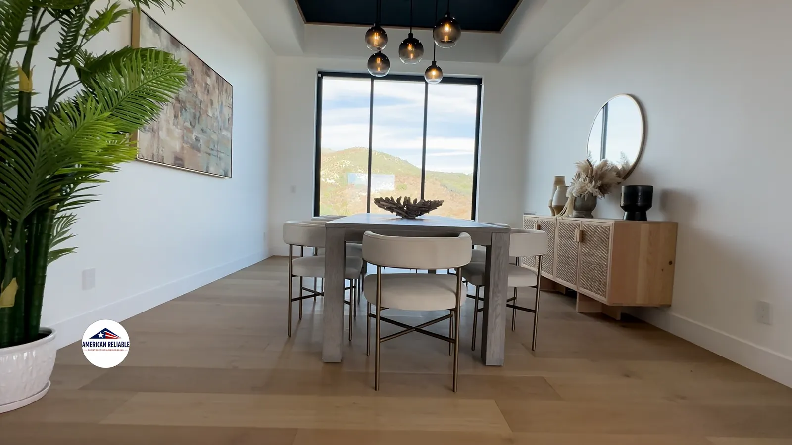 Renovated dining room with pendant lighting, hardwood floors and hillside views
